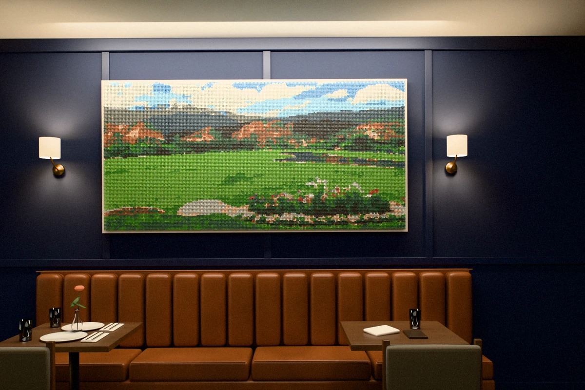 A large golf-tee picture of red rock formations and mountains in a club’s grill room.